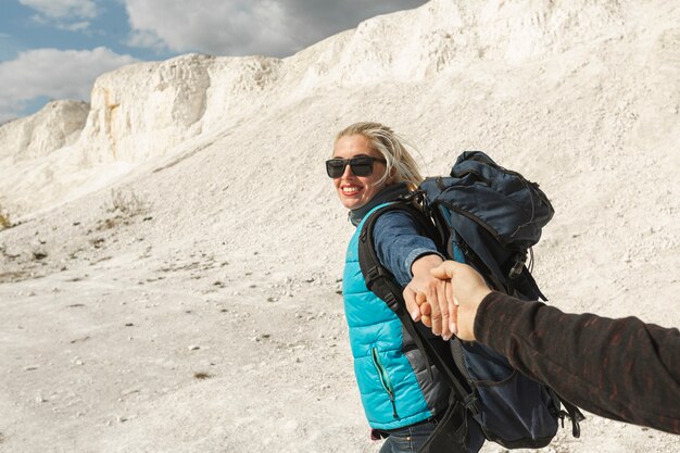 Smiley adult woman holding partners hand