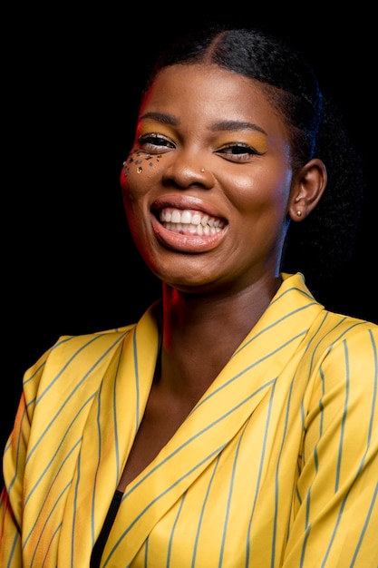 Free photo smiley african woman in yellow jacket