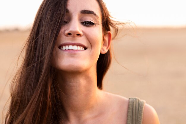 Smiley and alluring woman posing outdoors