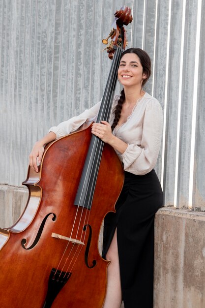Smiley artist with double bass medium shot