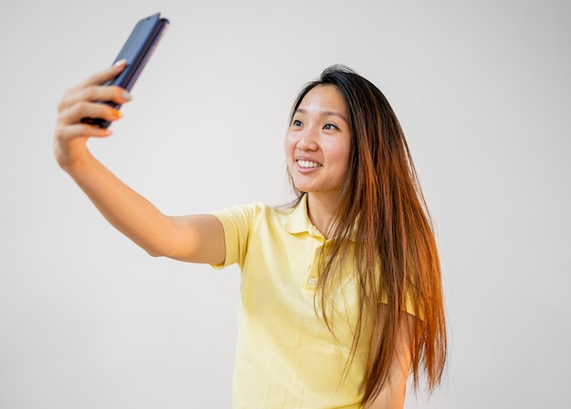 웃는 아시아 여자는 selfie를 복용
