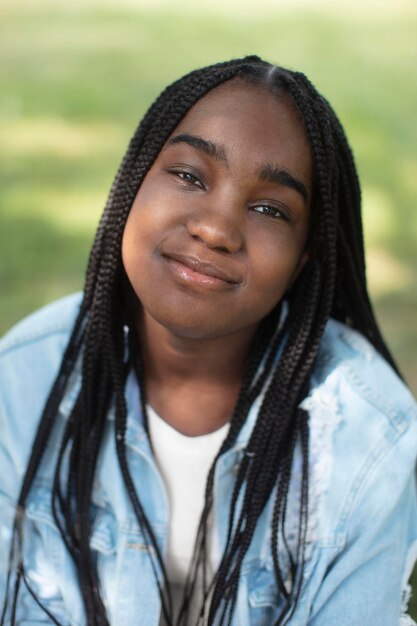 Smiley black teenage girl relaxing outdoors