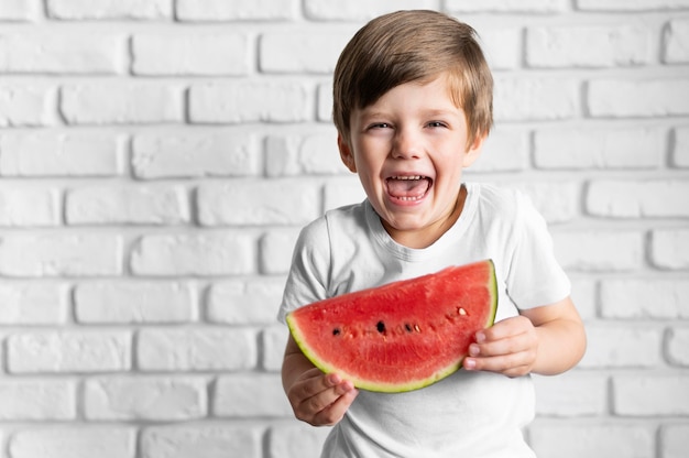 Smiley boy eating watermelon