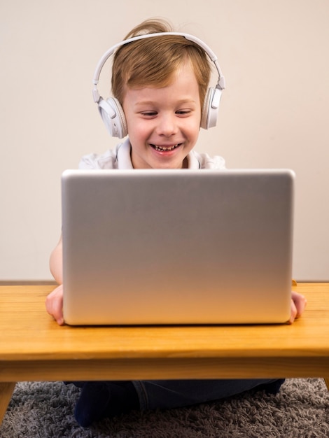 Free photo smiley boy playing a video game