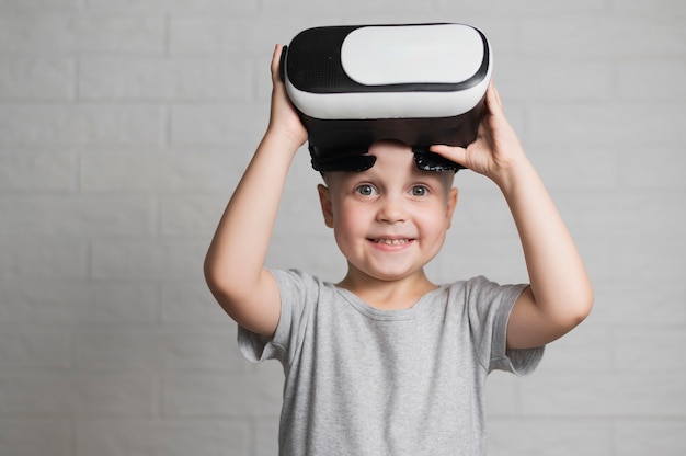 Smiley boy playing with vr headset