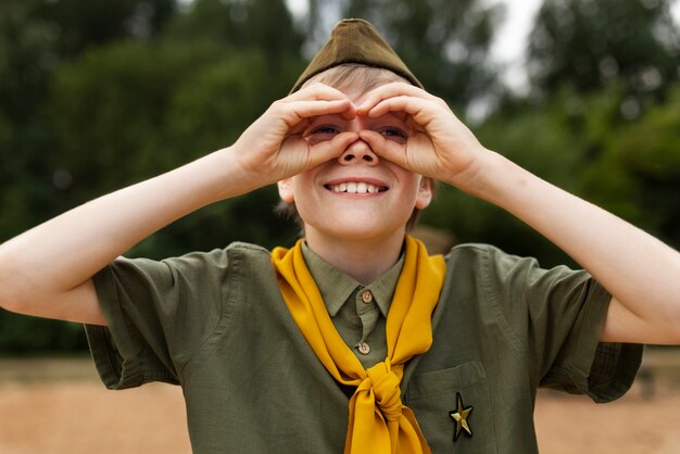 Smiley boy scout outdoors front view