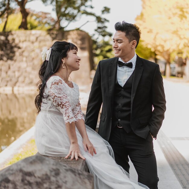 Smiley bride and groom outdoors together