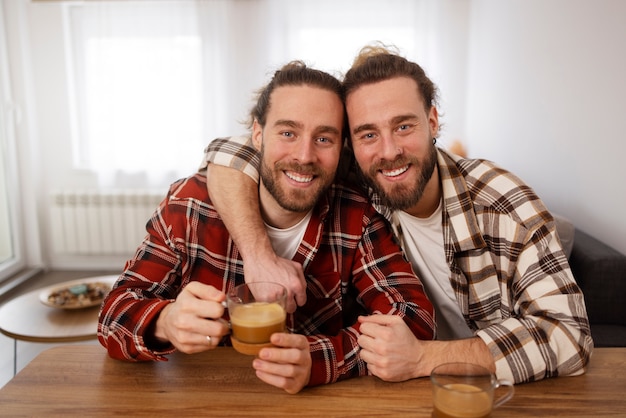 Free photo smiley brothers sitting at table front view