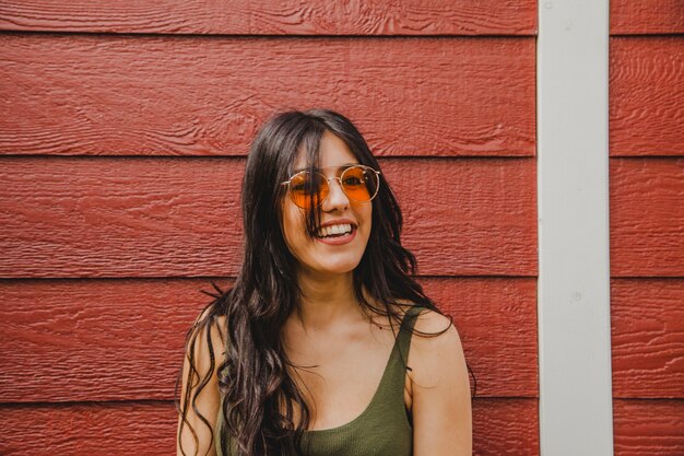 Smiley brunette with wooden background