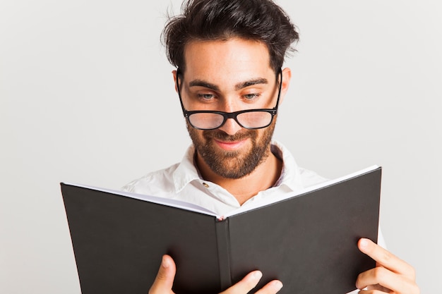 Free photo smiley businessman reading