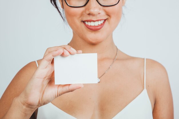 Smiley businesswoman showing business card