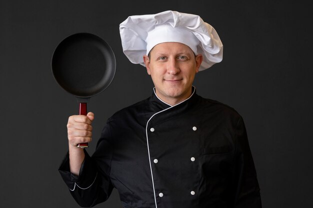 Smiley chef holding pan