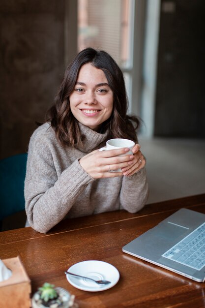 Smiley coffee shop owner working