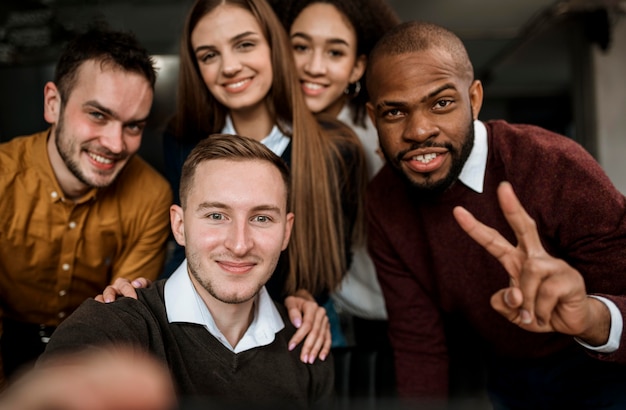 Smiley colleagues taking a selfie before a meeting