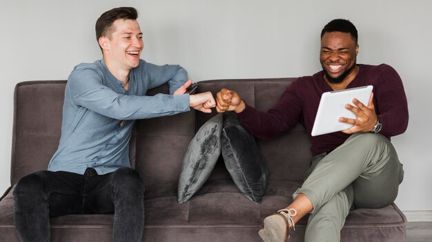 Smiley colleagues working during pandemic and fist bumping