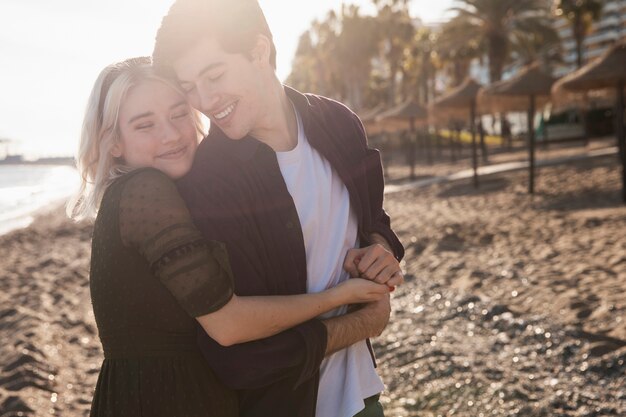 Smiley couple embraced at the beach