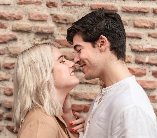 Smiley couple going for a kiss