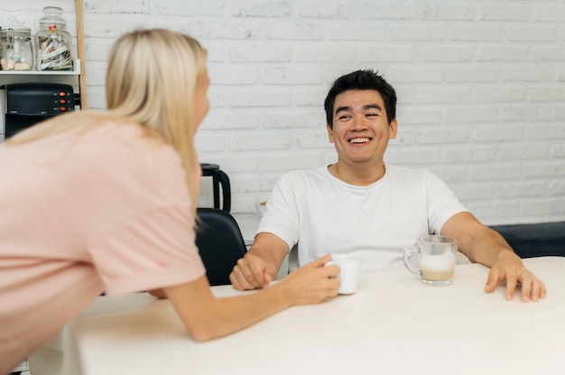 Smiley couple at home during the pandemic conversing