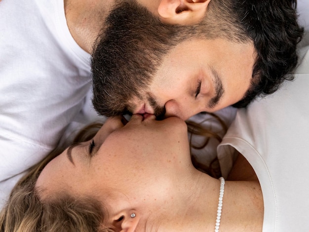 Smiley couple kissing at home