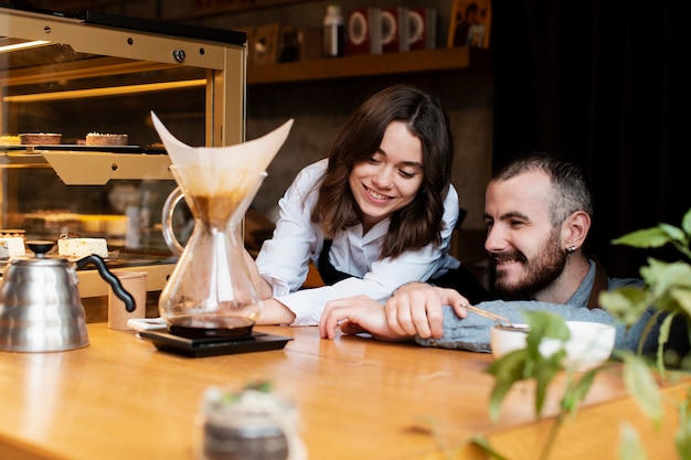 Smiley couple looking at coffee filter