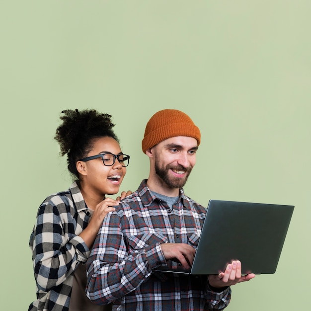 Smiley couple looking at laptop