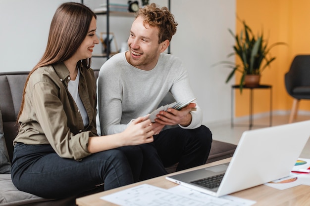 Free photo smiley couple making plans to remodel the home together