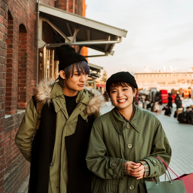 Free photo smiley couple outdoors medium shot