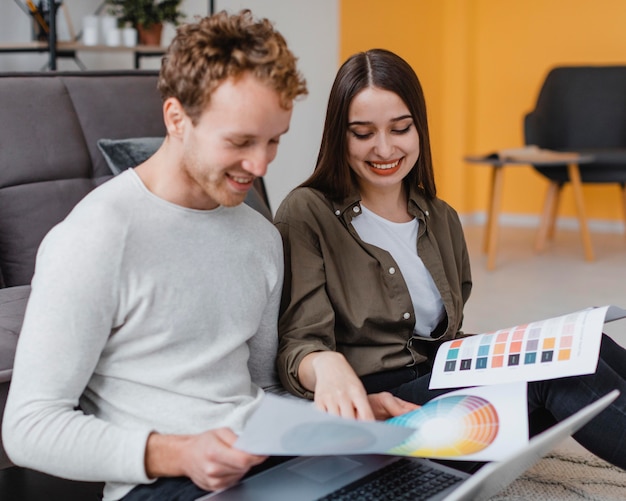 Smiley couple planning to redecorate the house