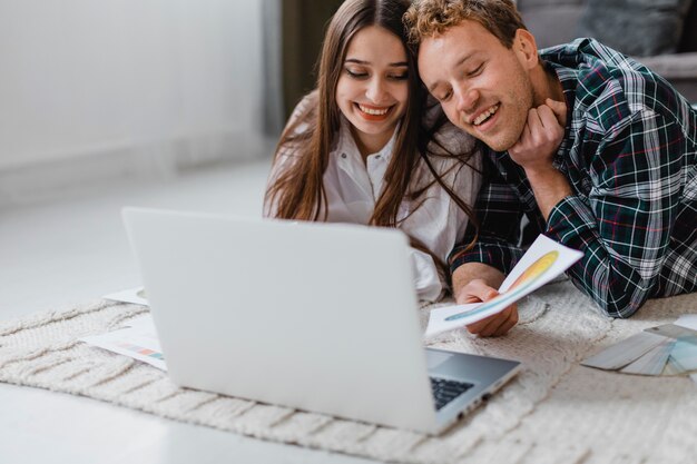 Smiley couple planning together to redecorate the home