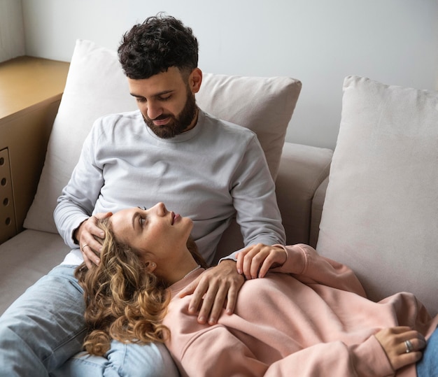 Smiley couple relaxing at home