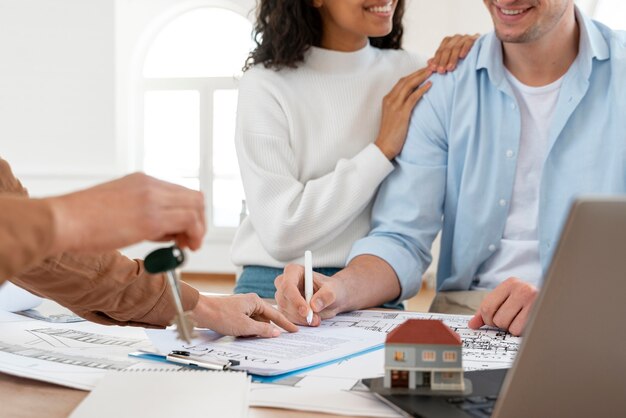 Smiley couple signing contract for new house