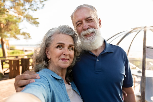 Free photo smiley couple taking selfie medium shot