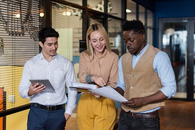 Smiley coworkers looking at documents together