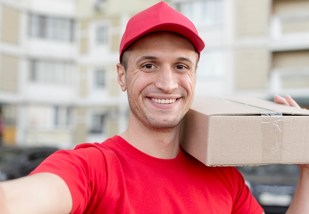 Smiley delivery guy taking selfie