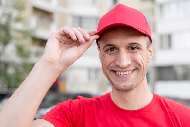 Smiley delivery guy wearing hat