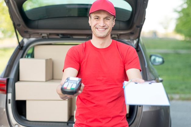 Smiley delivery guy with pos machine