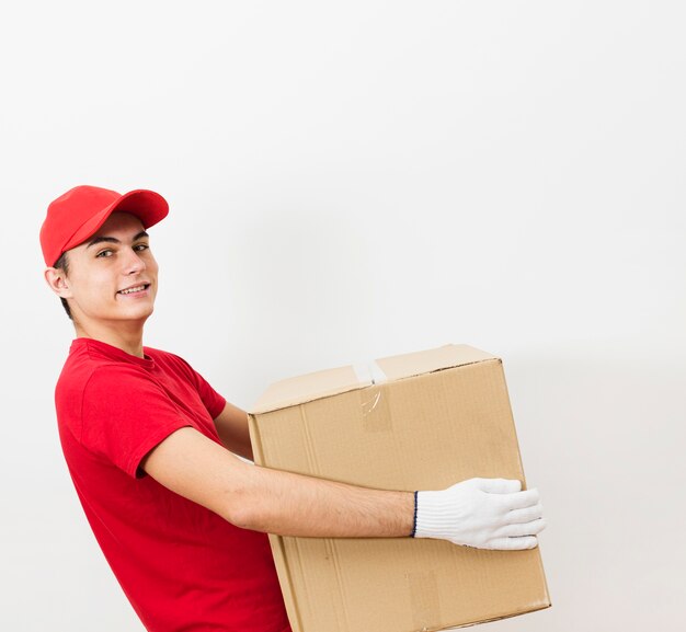 Smiley delivery man carrying package