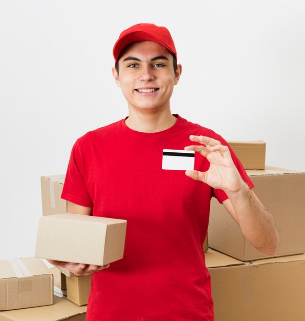 Smiley delivery man showing credit card