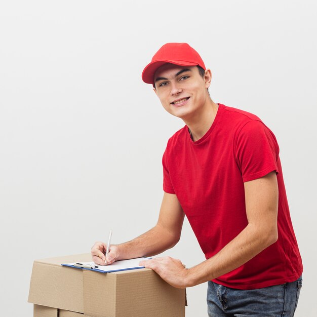 Smiley delivery man signing documents