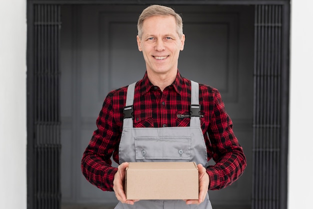 Smiley delivery man with package