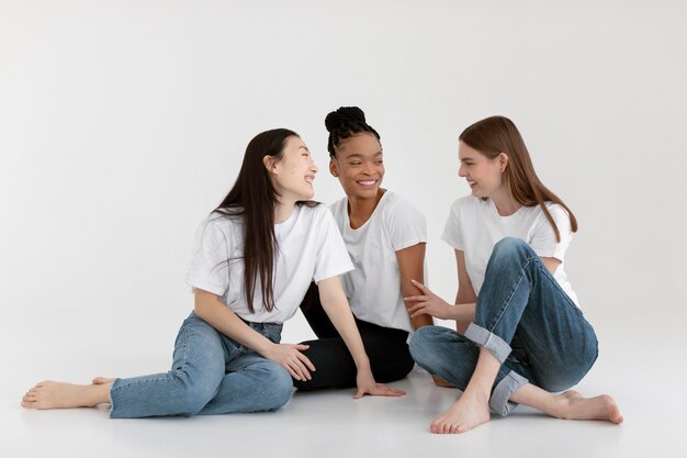 Smiley diverse women posing full shot