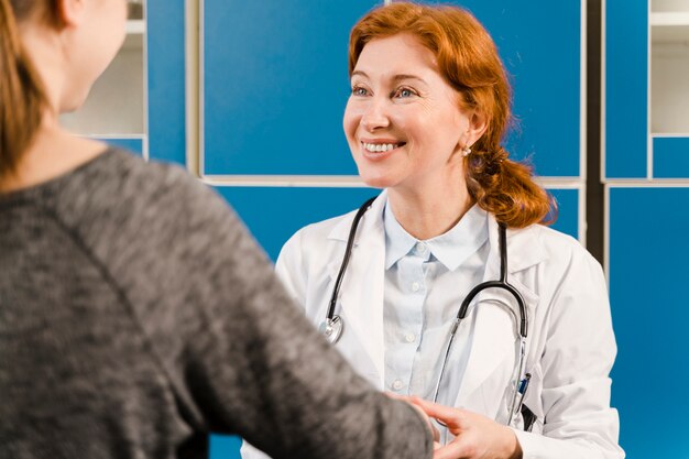 Smiley doctor looking at patient