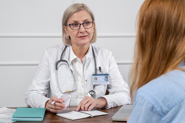 Smiley doctor talking to patient