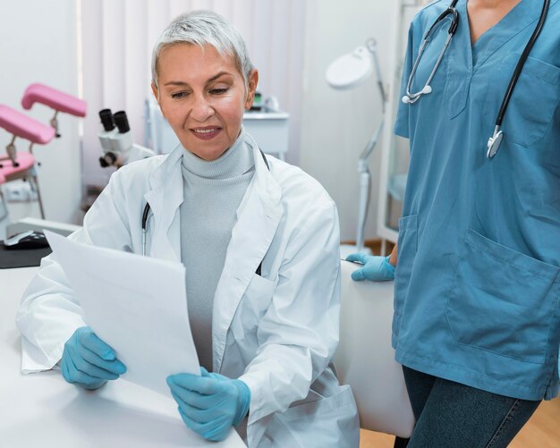 Smiley doctor talking with a nurse