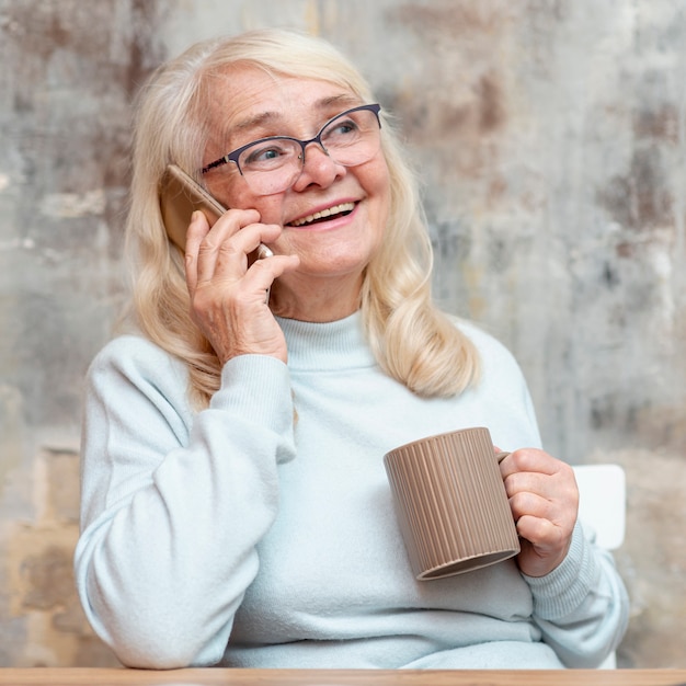 Smiley elder woman working from home