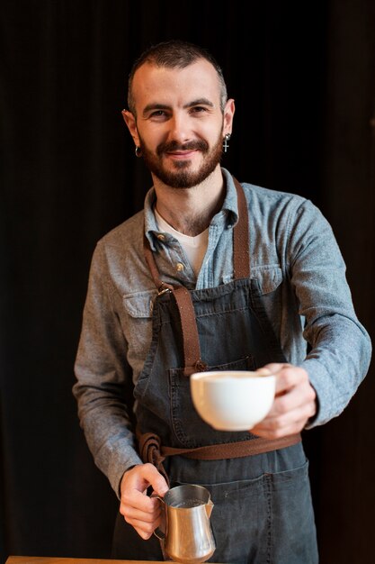 Smiley employee making coffee