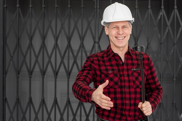 Free photo smiley engineer male ready to shake hand