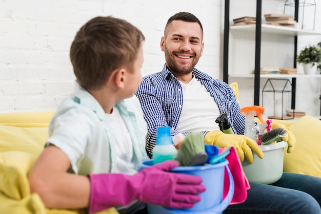 Smiley father and son cleaning