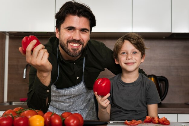 Smiley father and son in kitchen