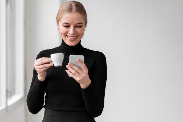 無料写真 スマイリーの女性がコーヒーを飲む